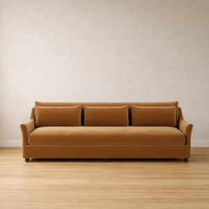 Brown sofa on a wooden floor with a beige wall background